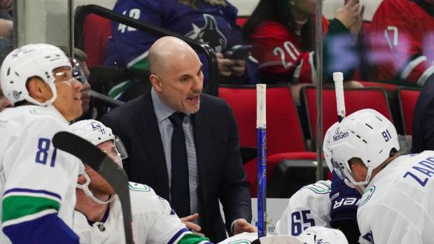 Feb 6, 2024; Raleigh, North Carolina, USA; Vancouver Canucks head coach Rick Tocchet talks to his players against the Carolina Hurricanes during the second period at PNC Arena. Mandatory Credit: James Guillory-USA TODAY Sports