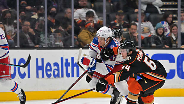 Jan 8, 2022; Anaheim, California, USA; New York Rangers center Kevin Rooney (17) and Anaheim Ducks right wing Jacob Perreault (64) chase down the puck in the second period of the game at Honda Center. Mandatory Credit: Jayne Kamin-Oncea-USA TODAY Sports