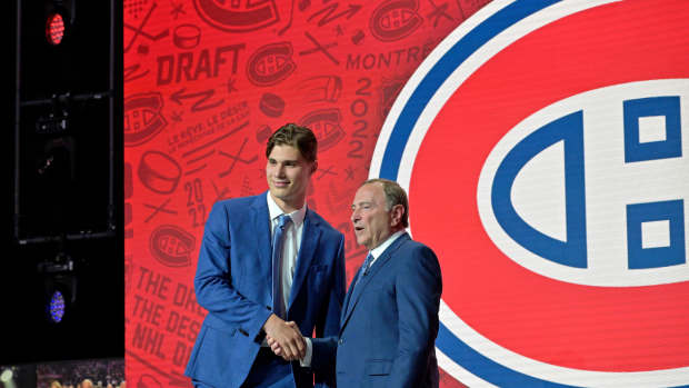 Jul 7, 2022; Montreal, Quebec, CANADA; Juraj Slafkovsky shakes hands with NHL commissioner Gary Bettman after being selected as the number one overall pick to the Montreal Canadiens in the first round of the 2022 NHL Draft at Bell Centre. Mandatory Credit: Eric Bolte-USA TODAY Sports