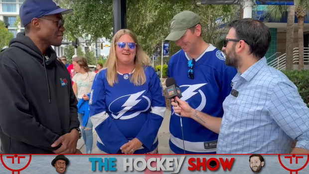 The Hockey Show hosts Roy Bellamy and David Dwork quiz hockey fans outside Amalie Arena on their Panthers and Lightning history. Source: Meadowlark Media