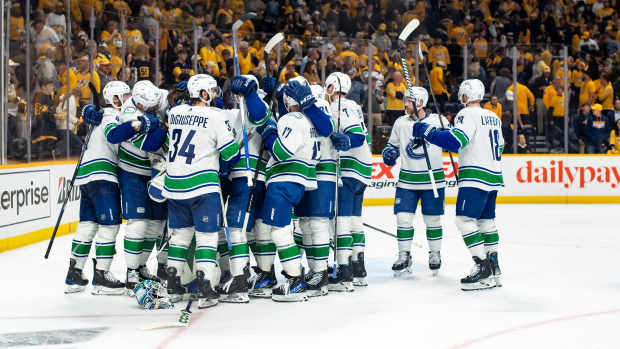 May 3, 2024; Nashville, Tennessee, USA; Vancouver Canucks celebrate the win against the Nashville Predators during game six of the first round of the 2024 Stanley Cup Playoffs at Bridgestone Arena. Mandatory Credit: Steve Roberts-USA TODAY Sports