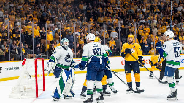 May 3, 2024; Nashville, Tennessee, USA; Vancouver Canucks celebrate the win against the Nashville Predators following game six of the first round of the 2024 Stanley Cup Playoffs at Bridgestone Arena. Mandatory Credit: Steve Roberts-USA TODAY Sports