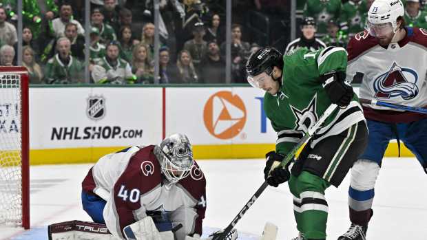 May 7, 2024; Dallas, Texas, USA; Dallas Stars center Logan Stankoven (11) attempts to redirect the puck past Colorado Avalanche goaltender Alexandar Georgiev (40) as center Yakov Trenin (73) looks on during the overtime period in game one of the second round of the 2024 Stanley Cup Playoffs at American Airlines Center.