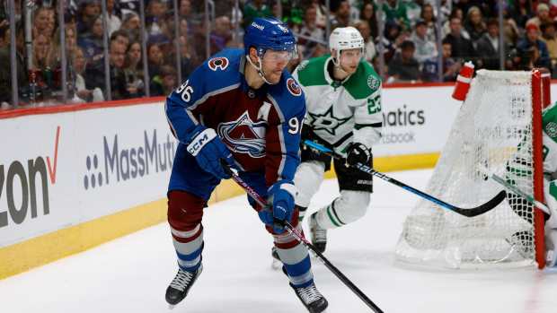 May 11, 2024; Denver, Colorado, USA; Colorado Avalanche right wing Mikko Rantanen (96) controls the puck ahead of Dallas Stars defenseman Esa Lindell (23) in the second period in game three of the second round of the 2024 Stanley Cup Playoffs at Ball Arena.