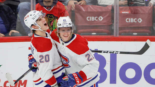 Dec 22, 2023; Chicago, Illinois, USA; Montreal Canadiens left wing Juraj Slafkovsky (20) celebrates with defenseman Kaiden Guhle (21) after scoring against the Chicago Blackhawks during the second period at United Center. Mandatory Credit: Kamil Krzaczynski-USA TODAY Sports