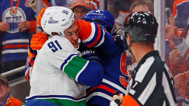May 18, 2024; Edmonton, Alberta, CAN; Edmonton Oilers forward Evander Kane (91) and Vancouver Canucks defensemen Nikita Zadorov (91) fight during the third period in game six of the second round of the 2024 Stanley Cup Playoffs at Rogers Place. Mandatory Credit: Perry Nelson-USA TODAY Sports