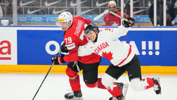 Connor Bedard (in white) had to haul down Switzerland's Calvin Thurkauf after losing the puck at the point during Canada's five-minute power play.