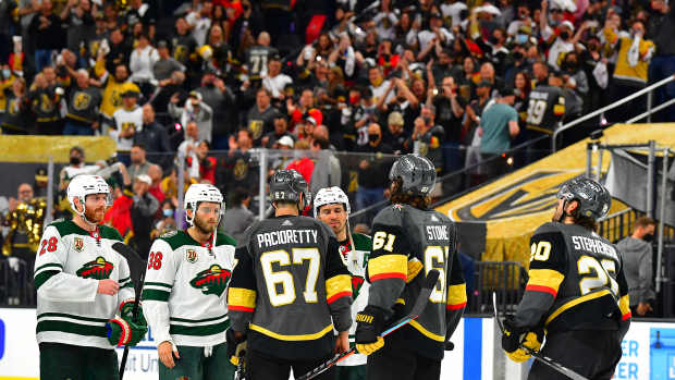 May 28, 2021; Las Vegas, Nevada, USA; Minnesota Wild players line up to shake hands with Vegas Golden Knights players after the Golden Knights defeated the Wild 6-2 in game seven of the first round of the 2021 Stanley Cup Playoffs at T-Mobile Arena. Mandatory Credit: Stephen R. Sylvanie-USA TODAY Sports