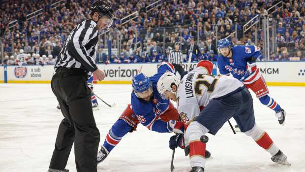 May 24, 2024; New York, New York, USA; New York Rangers center Vincent Trocheck (16) faces off against Florida Panthers center Eetu Luostarinen (27) during overtime in game two of the Eastern Conference Final of the 2024 Stanley Cup Playoffs at Madison Square Garden. Mandatory Credit: Vincent Carchietta-USA TODAY Sports  