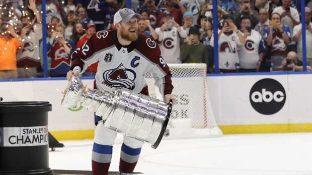 Jun 26, 2022; Tampa, Florida, USA; Colorado Avalanche left wing Gabriel Landeskog (92) celebrates with the Stanley Cup after the game against the Tampa Bay Lightning in game six of the 2022 Stanley Cup Final at Amalie Arena.