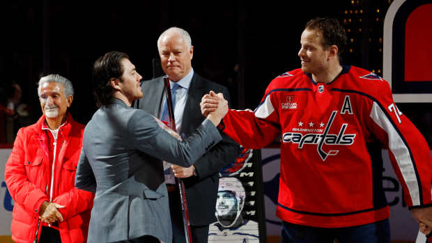 Apr 7, 2024; Washington, District of Columbia, USA; Washington Capitals defenseman John Carlson (74) shakes hands with Capitals right wing T.J. Oshie (L) at a ceremony honoring his 1,000th NHL game prior to the game against the Ottawa Senators at Capital One Arena. Mandatory Credit: Geoff Burke-USA TODAY Sports
