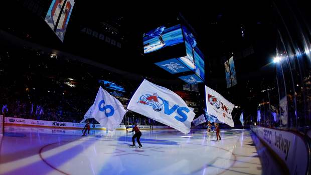 May 13, 2024; Denver, Colorado, USA; Colorado Avalanche ice patrol skate with flags before game four against the Dallas Stars in the second round of the 2024 Stanley Cup Playoffs at Ball Arena.