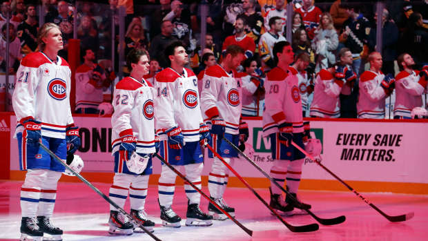 Feb 22, 2024; Pittsburgh, Pennsylvania, USA; Montreal Canadiens starting line up (L to R) defenseman Kaiden Guhle (21) and right wing Cole Caufield (22) and center Nick Suzuki (14) and defenseman Mike Matheson (8) and left wing Juraj Slafkovsky (20) stand for the Canadian National Anthem against the Pittsburgh Penguins at PPG Paints Arena. Mandatory Credit: Charles LeClaire-USA TODAY Sports