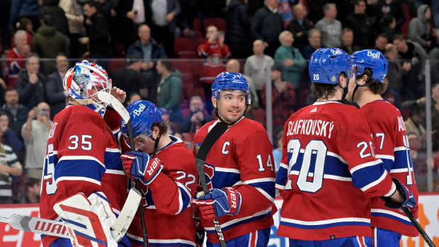 Apr 2, 2024; Montreal, Quebec, CAN; Montreal Canadiens goalie Sam Montembeault (35) celebrates the win against the Florida Panthers with teammates forward Cole Caufield (22) and forward Nick Suzuki (14) and forward Juraj Slafkovsky (20) at the Bell Centre. Mandatory Credit: Eric Bolte-Imagn Images