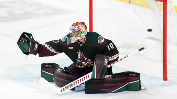 Arizona Coyotes goaltender Karel Vejmelka wears a helmet decorated with a  cross and a flag of the Czech Republic in an NHL hockey game against the  Seattle Kraken, Thursday, April 6, 2023