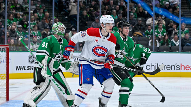 Jan 2, 2024; Dallas, Texas, USA; Montreal Canadiens left wing Juraj Slafkovsky (20) skates between Dallas Stars goaltender Scott Wedgewood (41) and defenseman Miro Heiskanen (4) during the first period at the American Airlines Center.