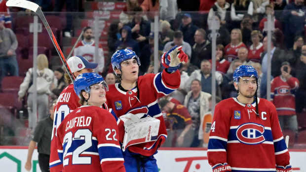 Apr 9, 2024; Montreal, Quebec, CAN; Montreal Canadiens forward Cole Caufield (22) and teammate forward Juraj Slafkovsky (20) celebrate the win against the Philadelphia Flyers at the Bell Centre. Mandatory Credit: Eric Bolte-Imagn Images