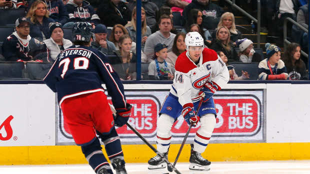 Nov 27, 2024; Columbus, Ohio, USA; Montreal Canadiens center Nick Suzuki (14) controls the puck as Columbus Blue Jackets defenseman Damon Severson (78) defends during the third period at Nationwide Arena. Mandatory Credit: Russell LaBounty-Imagn Images