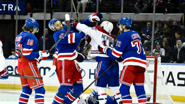 Nov 30, 2024; New York, New York, USA; New York Rangers defenseman K'Andre Miller (79) and Montreal Canadiens center Alex Newhook (15) scuffle during the second period at Madison Square Garden. Mandatory Credit: John Jones-Imagn Images