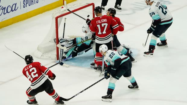 Dec 19, 2024; Chicago, Illinois, USA;Chicago Blackhawks defenseman Nolan Allan (42) scores a goal on Seattle Kraken goaltender Joey Daccord (35) during the third period at United Center. Mandatory Credit: David Banks-Imagn Images