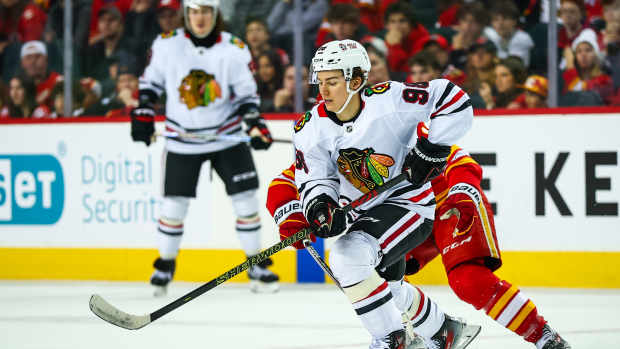 Dec 21, 2024; Calgary, Alberta, CAN; Chicago Blackhawks center Connor Bedard (98) controls the puck against the Calgary Flames during the third period at Scotiabank Saddledome. Mandatory Credit: Sergei Belski-Imagn Images