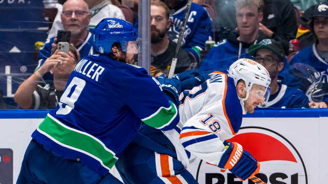 May 10, 2024; Vancouver, British Columbia, CAN; Vancouver Canucks forward J.T. Miller (9) checks Edmonton Oilers forward Zach Hyman (18) during the third period in game two of the second round of the 2024 Stanley Cup Playoffs at Rogers Arena. Mandatory Credit: Bob Frid-USA TODAY Sports
