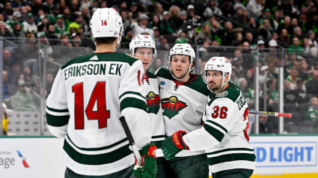 Jan 10, 2024; Dallas, Texas, USA; Minnesota Wild center Joel Eriksson Ek (14) and left wing Matt Boldy (12) and defenseman Brock Faber (7) and right wing Mats Zuccarello (36) celebrates a goal scored by Boldy against the Dallas Stars during the third period at the American Airlines Center. Mandatory Credit: Jerome Miron-USA TODAY Sports