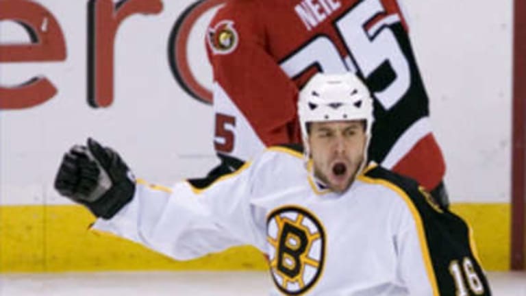Boston Bruins' Glen Murray, center celebrates his goal with teammates Marc  Savard (91) and Patrice Bergeron (37) during the second period of an NHL  hockey game against the Ottawa Senators in Boston