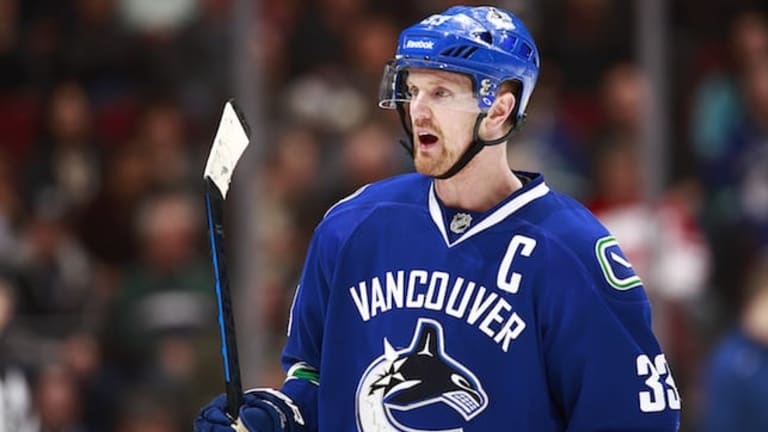One of the Vancouver Canucks Sedin twins gives his signed jersey