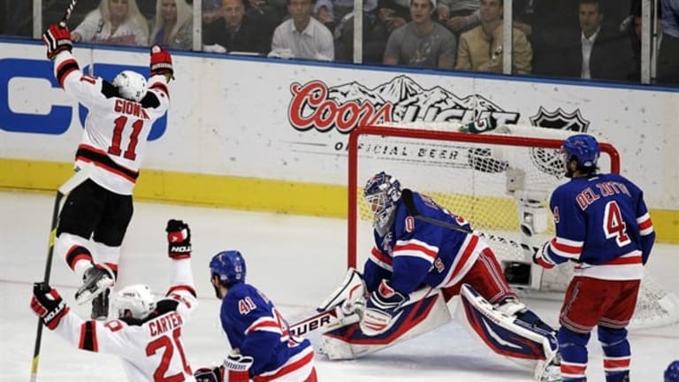 New Jersey Devils Ryan Carter gets the puck past New York Rangers