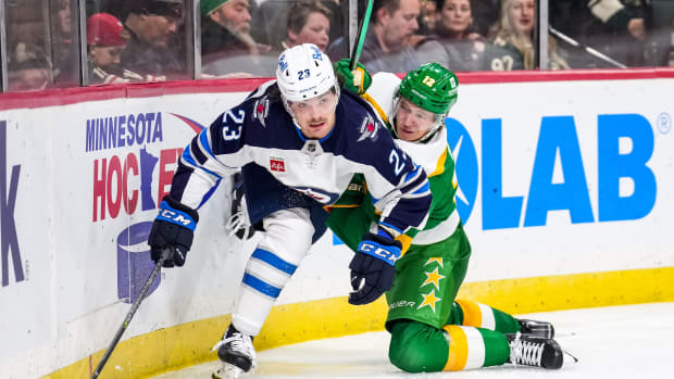 Tampa Bay Lightning center Michael Eyssimont (23) battles for the