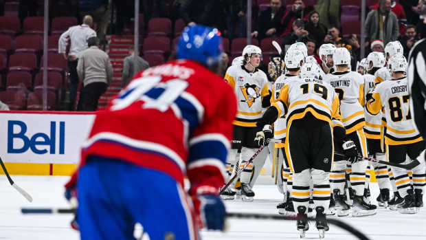 Dec 12, 2024; Montreal, Quebec, CAN; Pittsburgh Penguins players gather to celebrate the win against the Montreal Canadiens after the end of the game at Bell Centre. Mandatory Credit: David Kirouac-Imagn Images