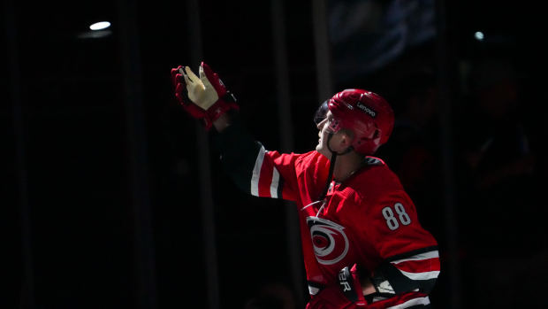 Nov 7, 2023; Raleigh, North Carolina, USA; Carolina Hurricanes center Martin Necas (88) tosses a puck into the stands after their win against the Buffalo Sabres in the over time at PNC Arena. 