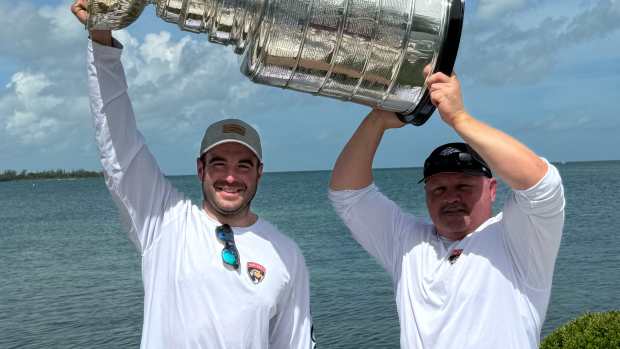 Panthers Head Strength and Conditioning Coach Mike Joyce (left) and VP of Sports Performance Chris McLellan (right) hoist the Stanley Cup (center) during a fishing trip in the Florida Keys. 