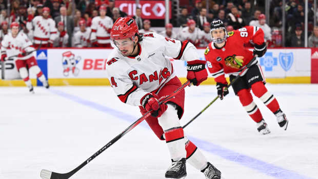 Apr 14, 2024; Chicago, Illinois, USA; Carolina Hurricanes forward Seth Jarvis (24) controls the puck in the second period against the Chicago Blackhawks at United Center. 