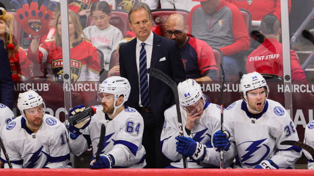 Apr 21, 2024; Sunrise, Florida, USA; Tampa Bay Lightning head coach Jon Cooper looks on from the bench against the Florida Panthers during the third period in game one of the first round of the 2024 Stanley Cup Playoffs at Amerant Bank Arena. 