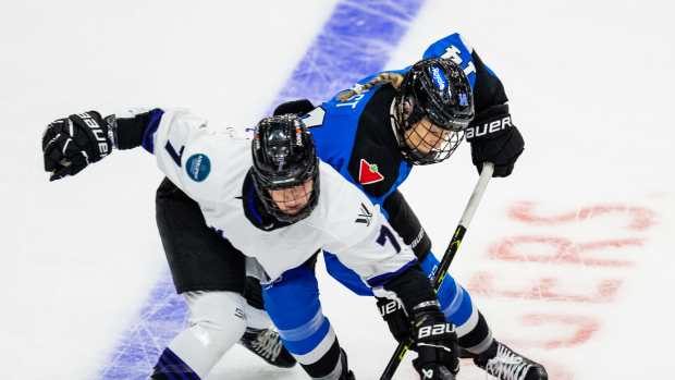 Renata Fast of PWHL Toronto fights for a puck with PWHL Minnesota's Claire Butorac in the opening game of the PWHL playoffs