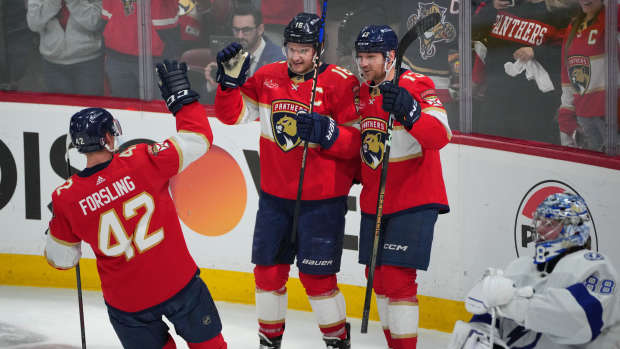 Apr 29, 2024; Sunrise, Florida, USA; Florida Panthers center Aleksander Barkov (16) celebrates a short-handed goal with center Sam Reinhart (13) and defenseman Gustav Forsling (42) against the Tampa Bay Lightning during the second period in game five of the first round of the 2024 Stanley Cup Playoffs at Amerant Bank Arena. Mandatory Credit: Jim Rassol-USA TODAY Sports  