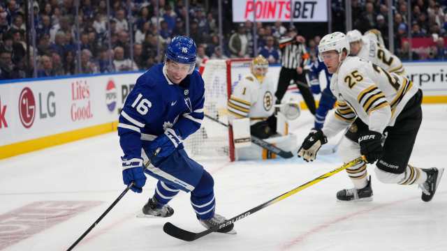 Mitch Marner controls the puck against Brandon Carlo.