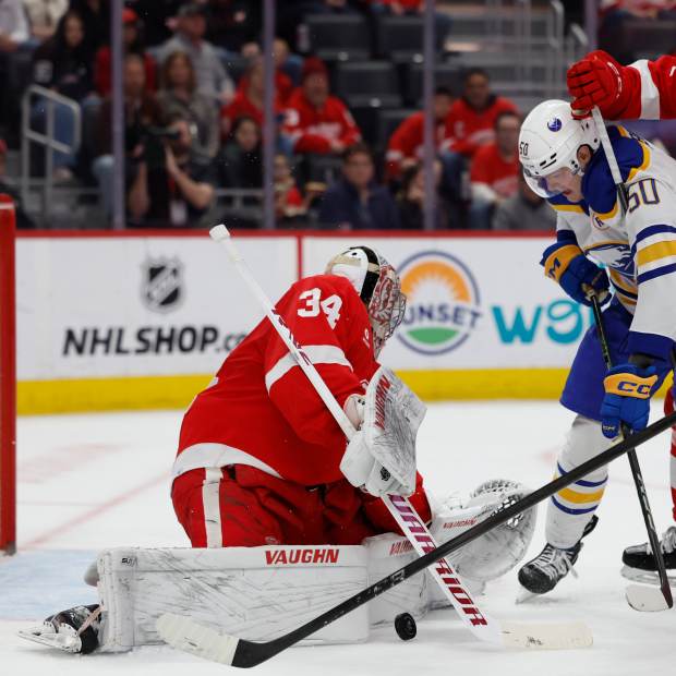 Detroit Red Wings goaltender Alex Lyon (34) makes a save on Buffalo Sabres left wing Eric Robinson (50)