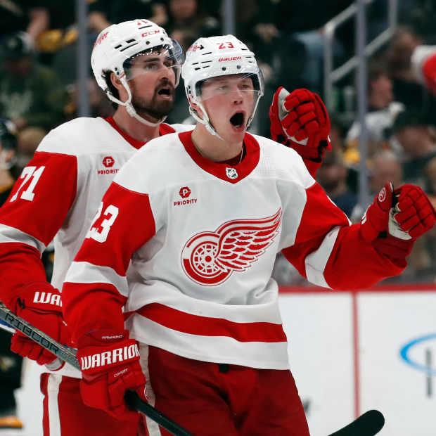 Apr 11, 2024; Pittsburgh, Pennsylvania, USA; Detroit Red Wings center Dylan Larkin (71) and left wing Lucas Raymond (23) celebrate after Raymond scored a goal to complete a hat-trick against the Pittsburgh Penguins during the third period at PPG Paints Arena