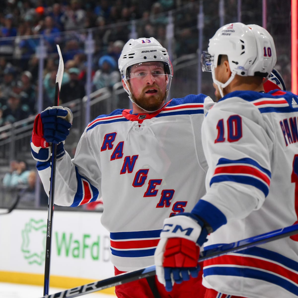 New York Rangers left wing Artemi Panarin, right, celebrates his goal with  right wing Pavel Buchnevich (89) and center Mika Zibanejad (93) during the  second period of an NHL pre-season hockey game