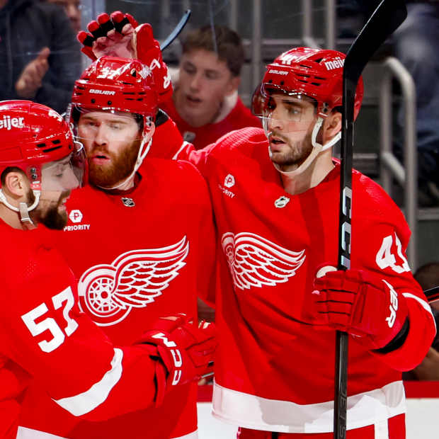 Detroit Red Wings left wing J.T. Compher (37) receives congratulations from teammates