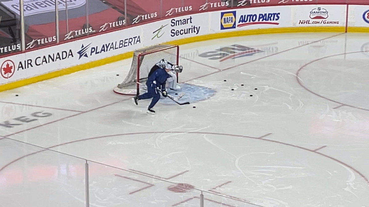 Toronto Maple Leafs goaltender Jack Campbell works on drills with goalie coach Steve Briere in Calgary.