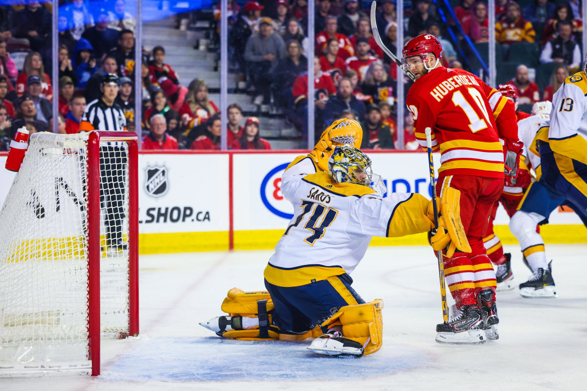 Nashville Predators center Tommy Novak (82) maneuvers in front of Calgary  Flames center Blake Coleman (20) during the second period of an NHL hockey  game Monday, Jan. 16, 2023, in Nashville, Tenn. (