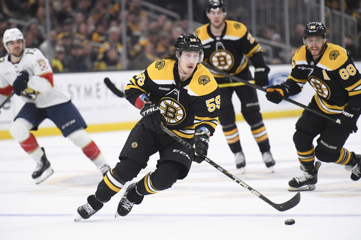 Boston Bruins' Tyler Bertuzzi (59) skates with the puck against