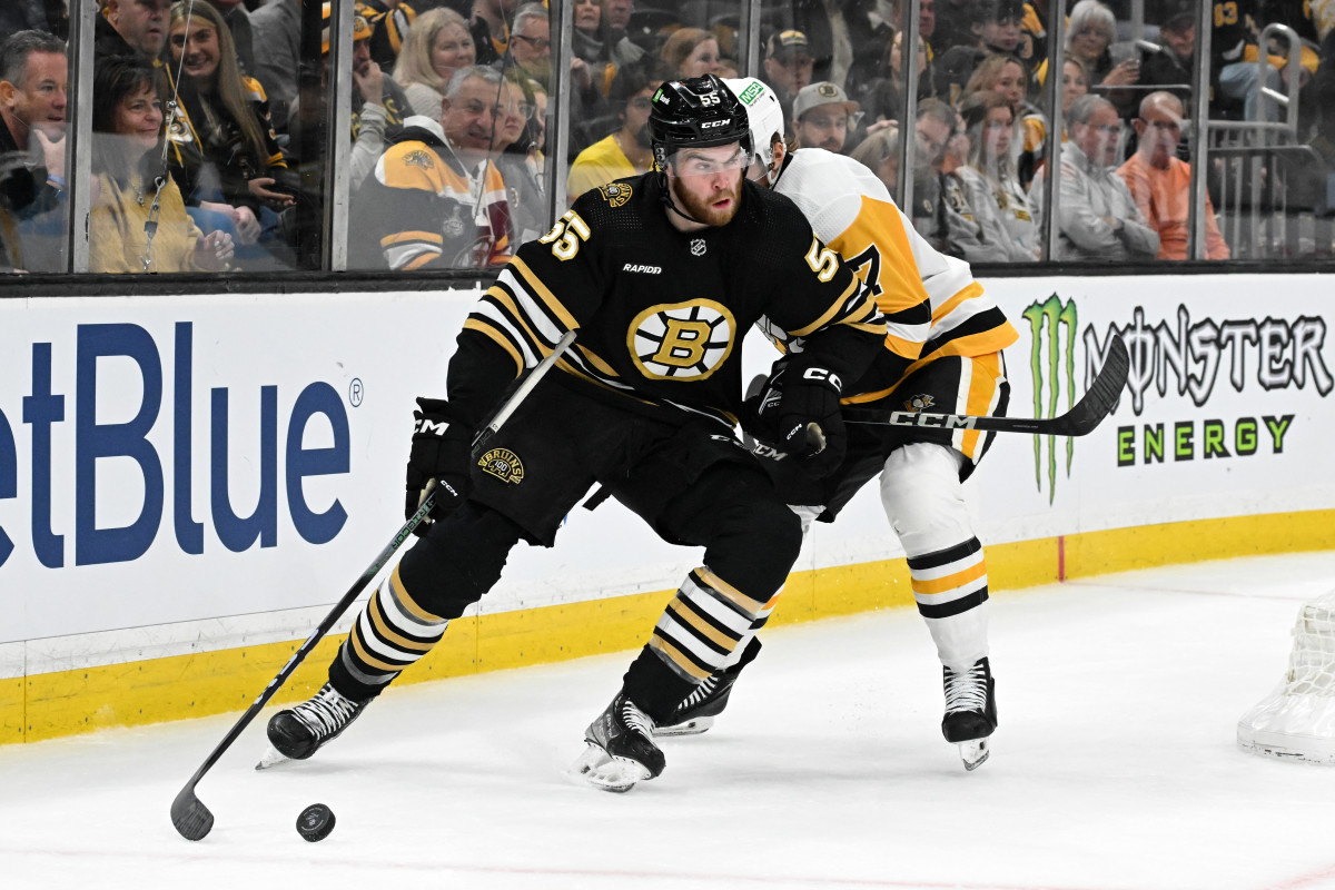 Mar 9, 2024; Boston, Massachusetts, USA; Boston Bruins right wing Justin Brazeau (55) controls the puck against Pittsburgh Penguins defenseman John Ludvig (7) during the third period at the TD Garden. Mandatory Credit: Brian Fluharty-USA TODAY Sports