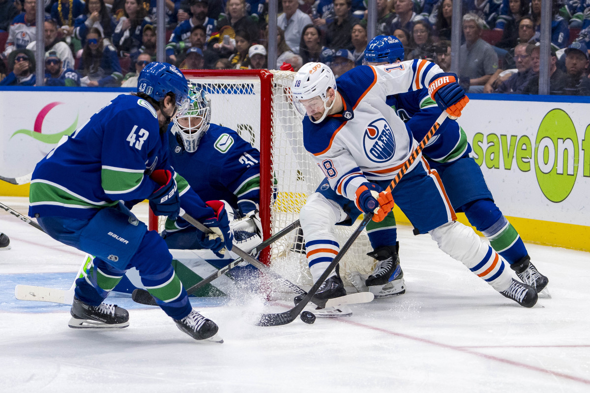 May 10, 2024; Vancouver, British Columbia, CAN; Vancouver Canucks goalie Arturs Silvos (31) watches as defenseman Quinn Hughes (43) and defenseman Filip Hronek (17) check Edmonton Oilers forward Zach Hyman (18) during the first overtime in game two of the second round of the 2024 Stanley Cup Playoffs at Rogers Arena. Mandatory Credit: Bob Frid-USA TODAY Sports