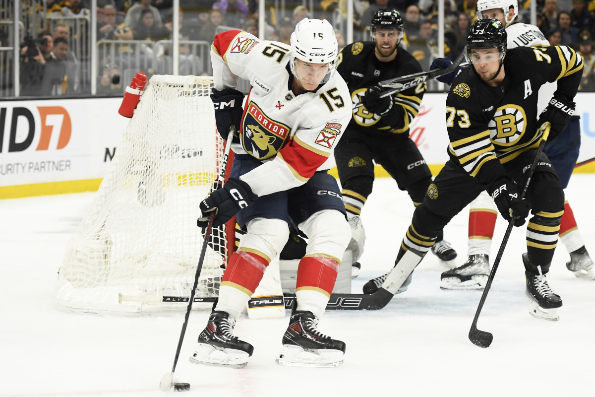 May 12, 2024; Boston, Massachusetts, USA; Florida Panthers center Anton Lundell (15) controls the puck while Boston Bruins defenseman Charlie McAvoy (73) defends during the second period in game four of the second round of the 2024 Stanley Cup Playoffs at TD Garden. Mandatory Credit: Bob DeChiara-USA TODAY Sports