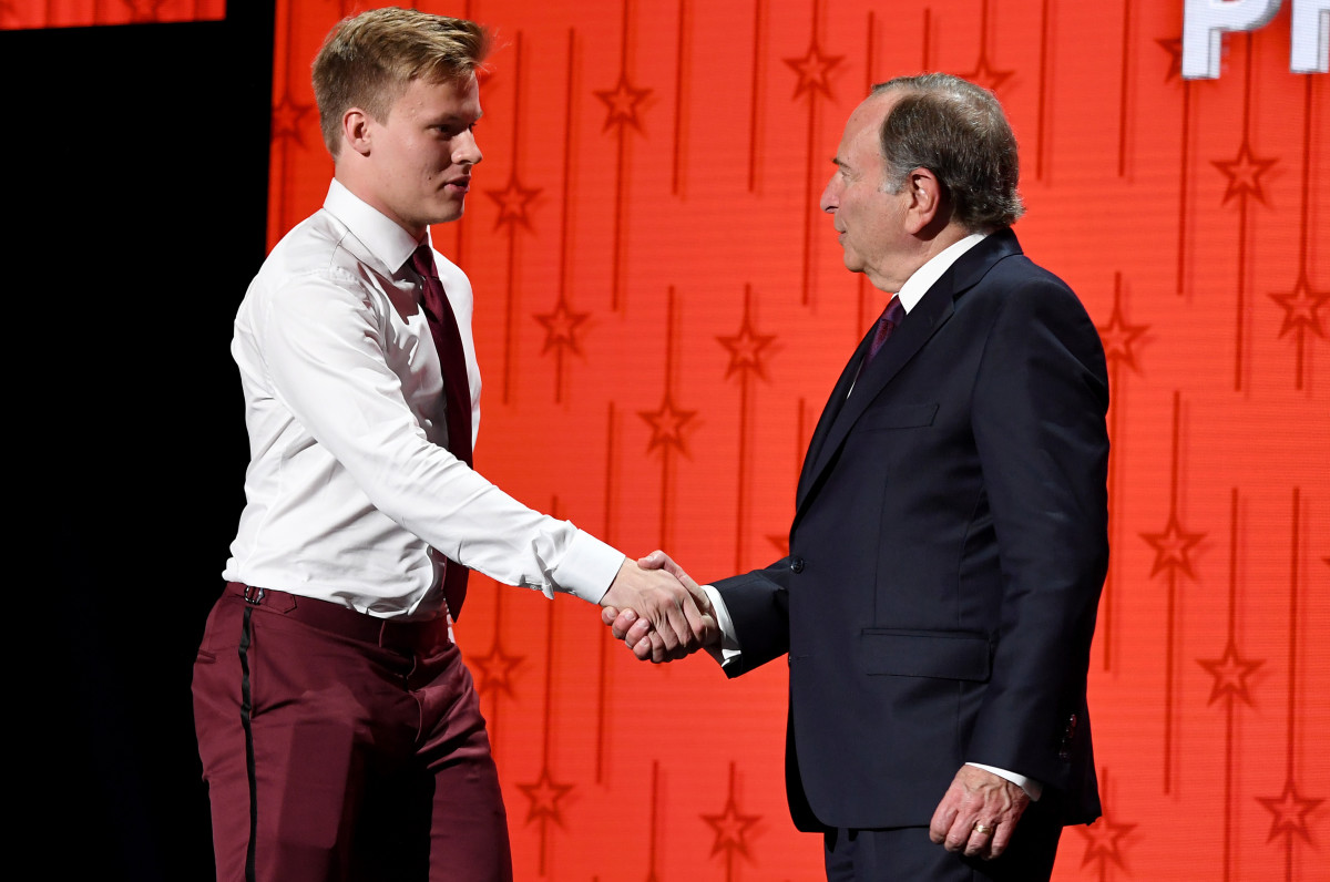 Philadelphia Flyers draft pick Matvei Michkov shakes hands with NHL commissioner Gary Bettman after being selected with the seventh pick in round one of the 2023 NHL Draft at Bridgestone Arena.